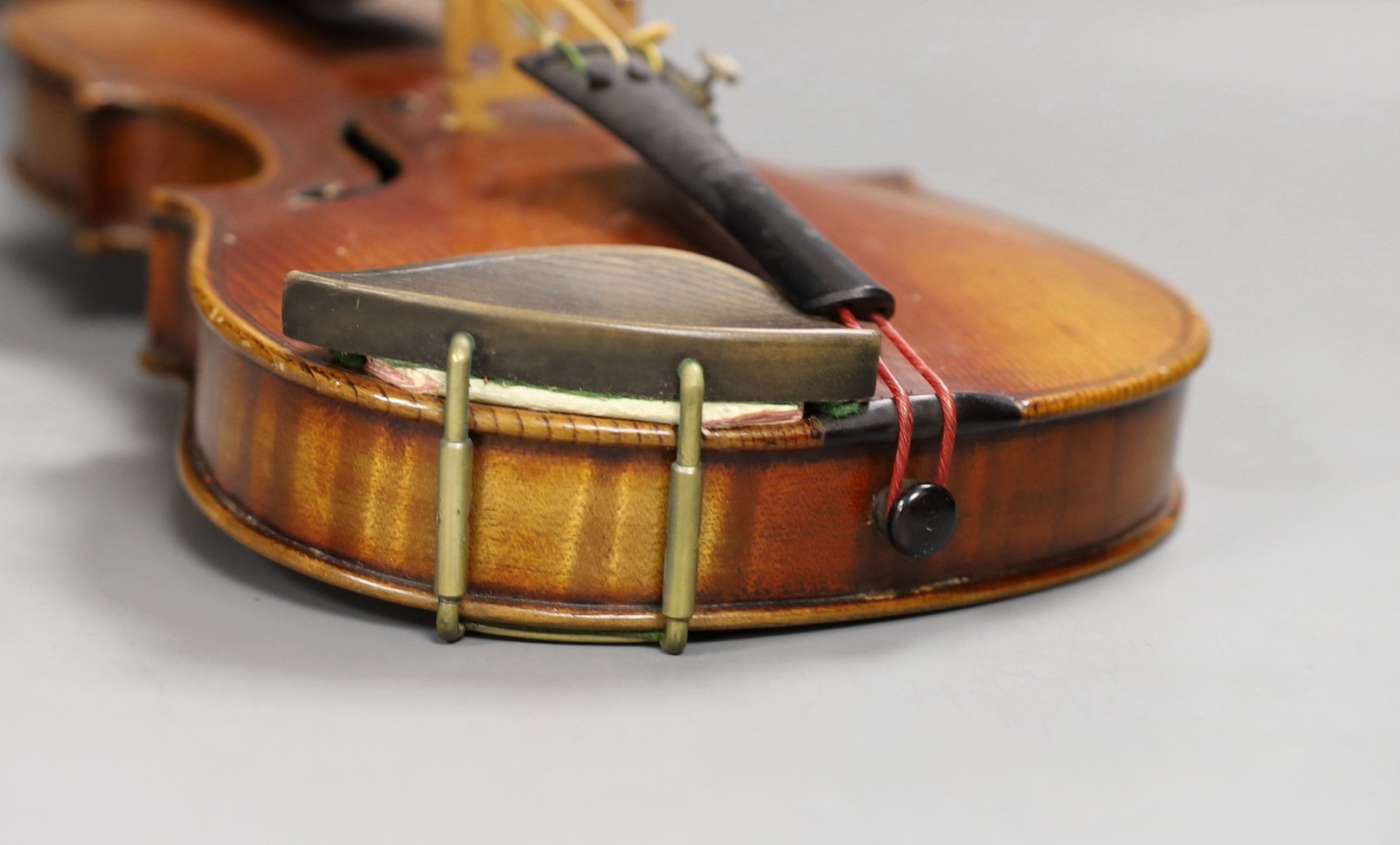 A quarter size late 19th century violin with bow, in E. Hill & Sons case, back measures 29cm